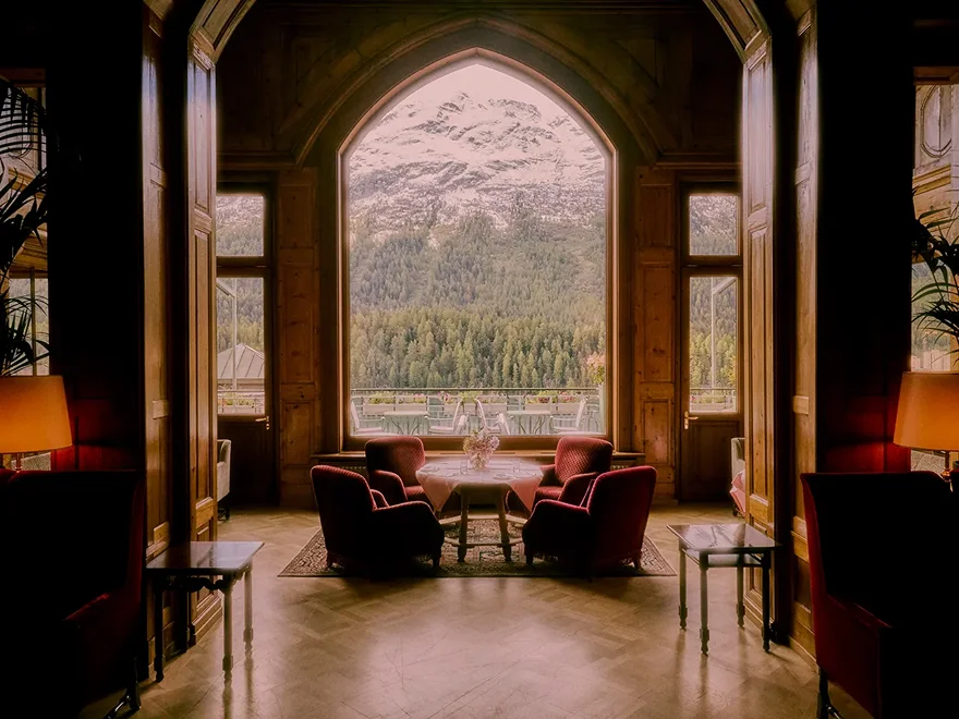 Arched windows and armchairs looking out over the Engadin valley