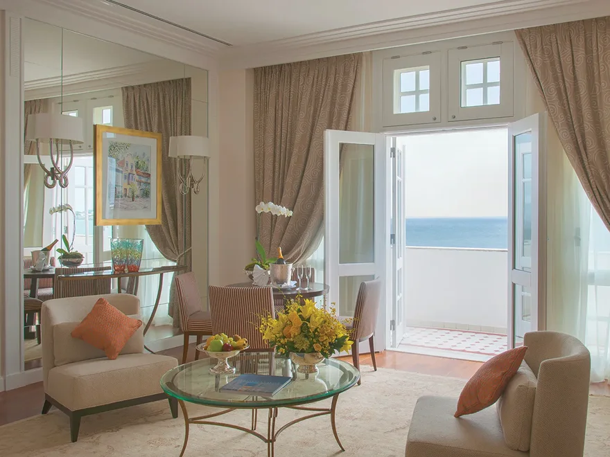 A sitting room with french doors opening toward Copacabana beach