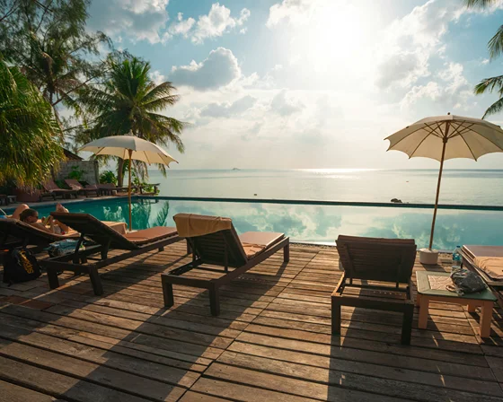 A suite with tall windows and a view over the water