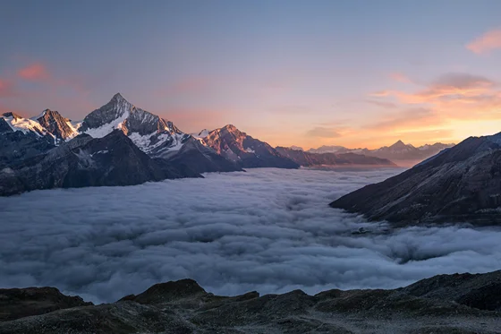 Snow-capped peaks reflected in a still mountain lake