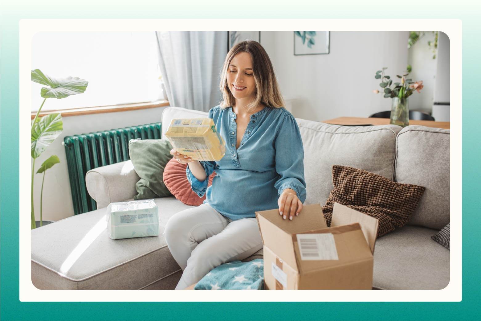 woman on sofa looking at package of diapers she pulled out of brown box next to her
