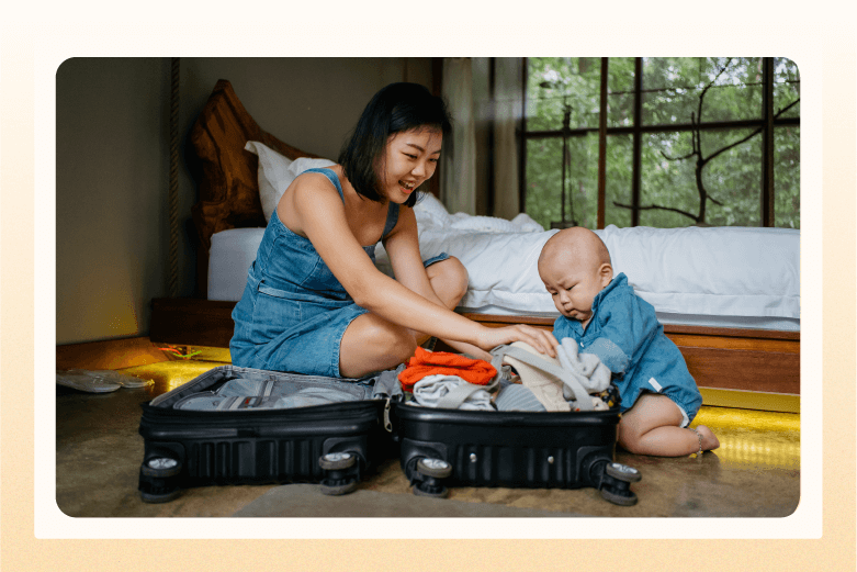 woman trying to pack carry-on luggage while baby plays with the clothes in bag