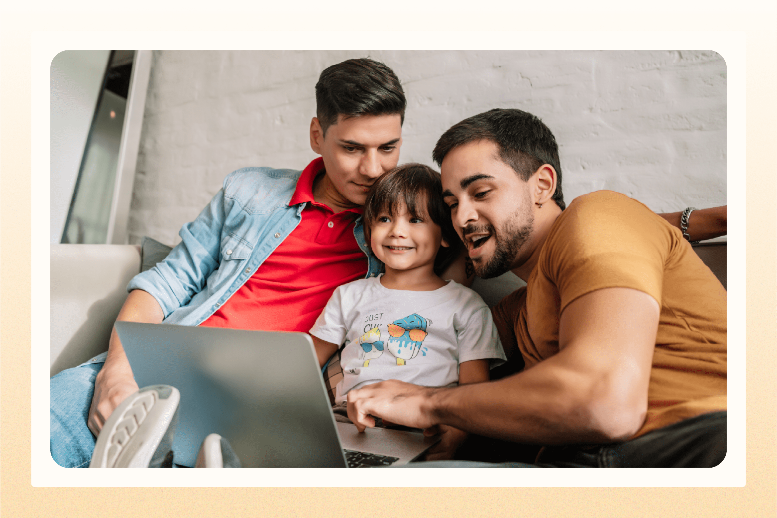 Male couple with toddler looking at laptop
