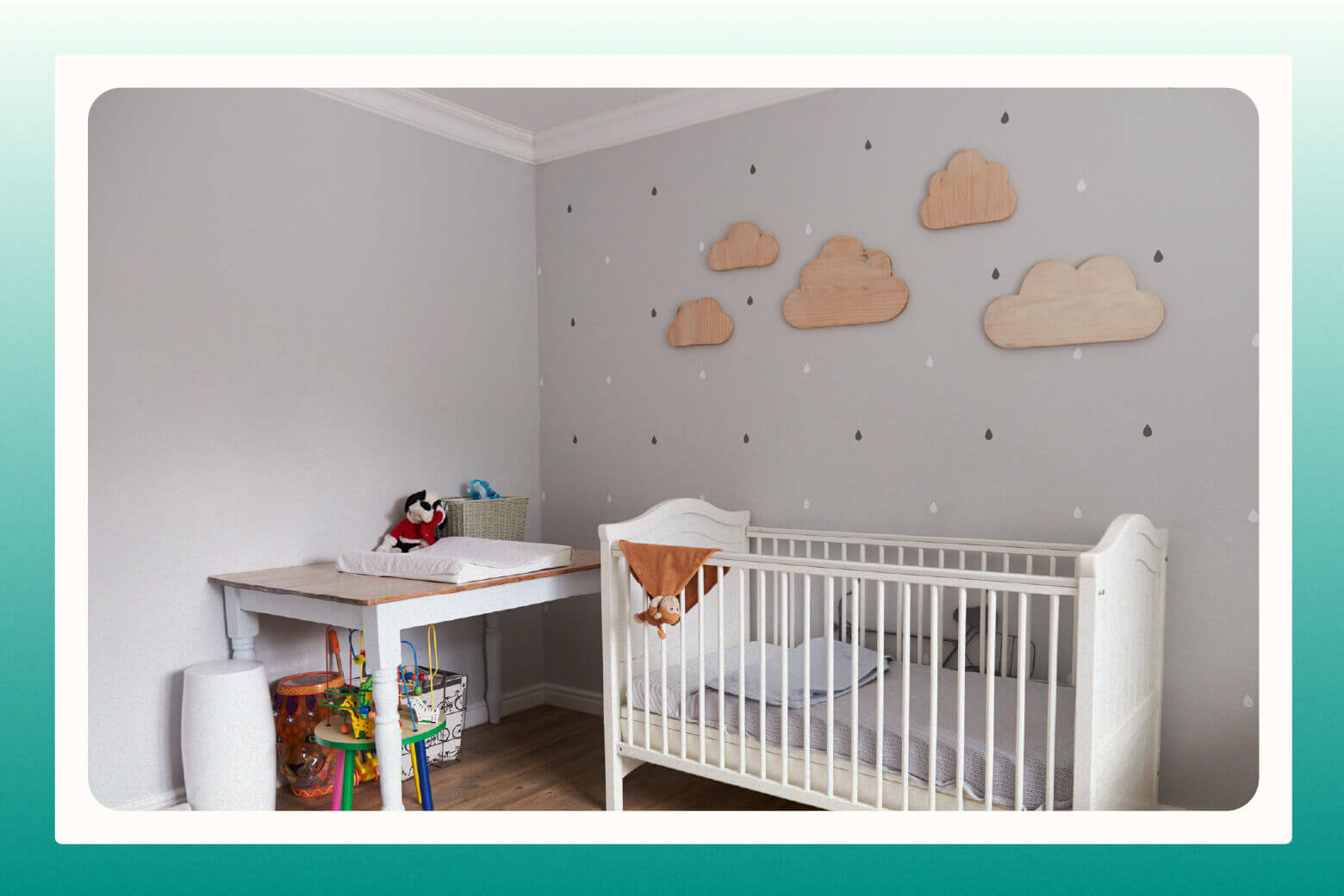 Baby's neutral nursery idea with gray walls that have clouds and raindrops on them