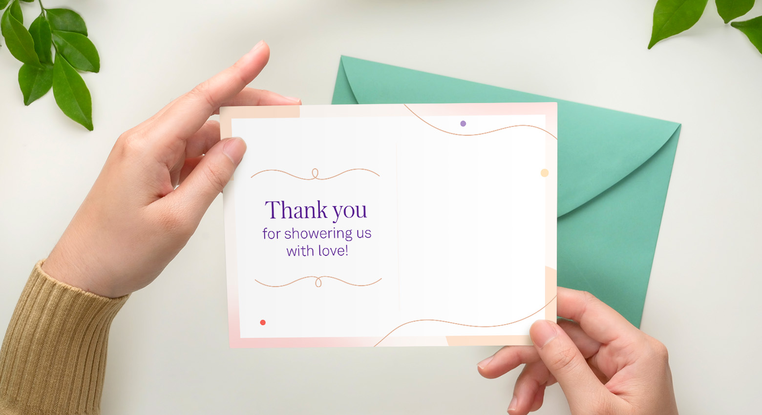 Two hands hold a printable thank you card open and it says "Thank you for showering us with love"