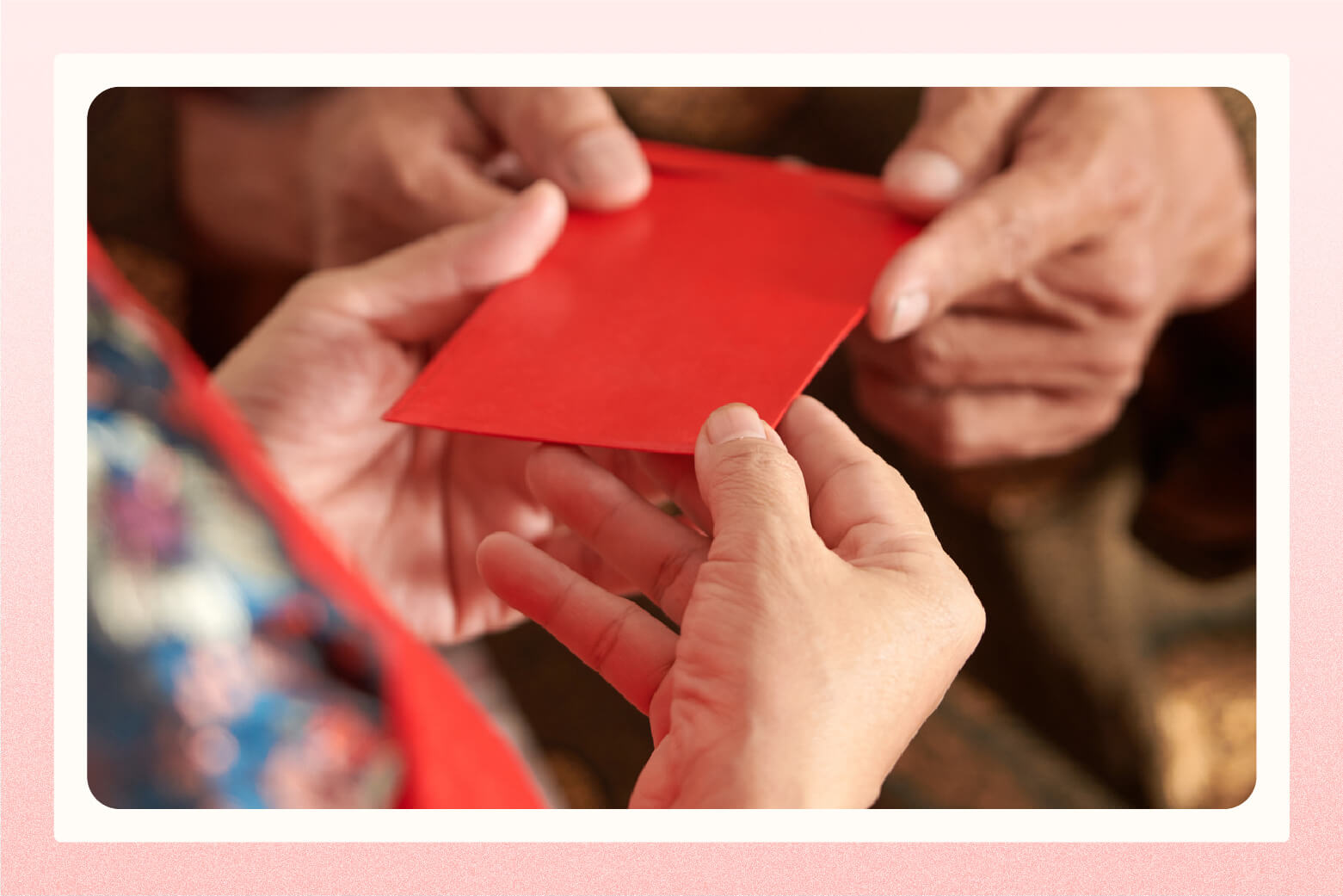 close up of hands exchanging a red envelope gift