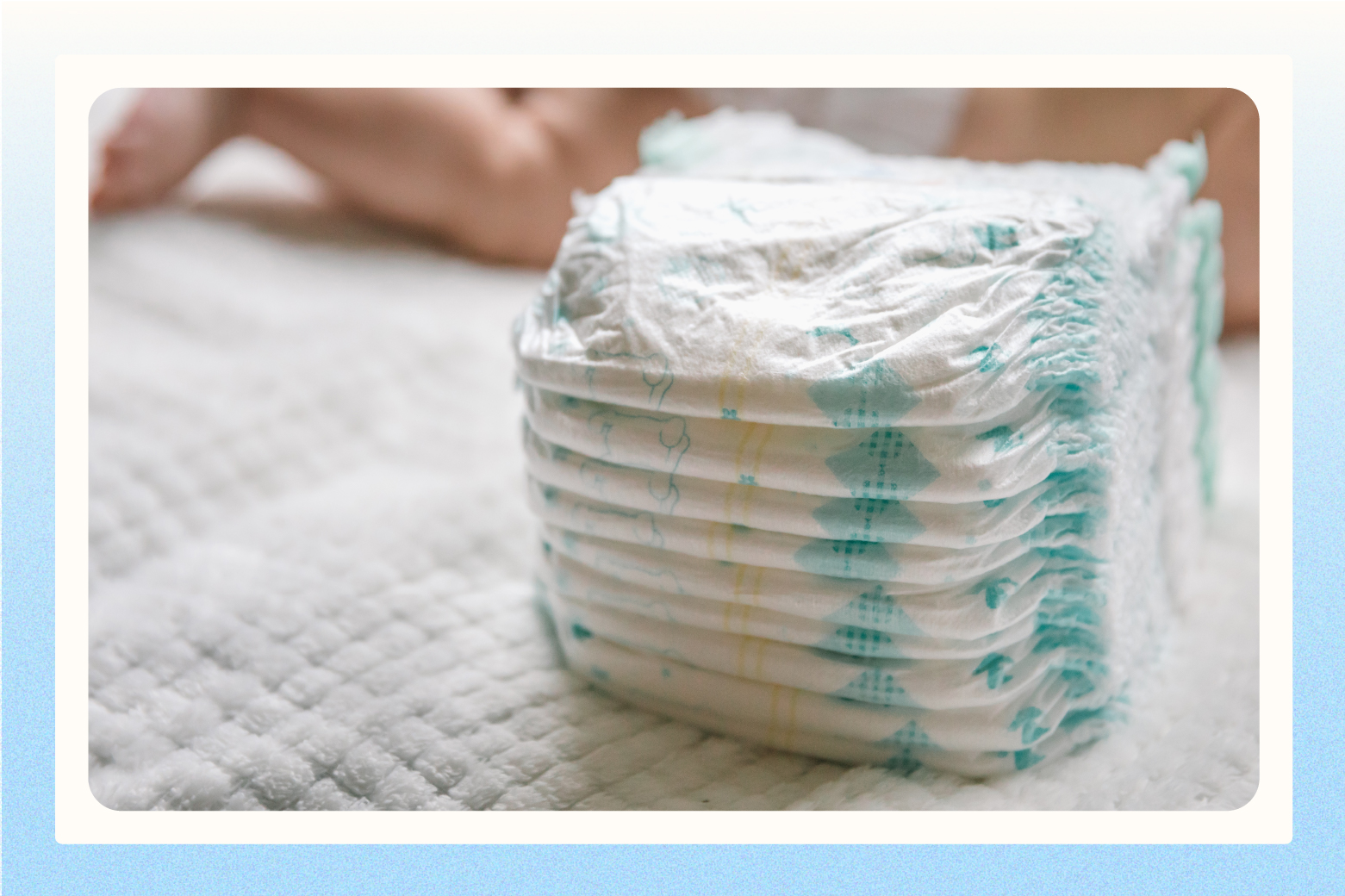 stack of diapers with baby in background