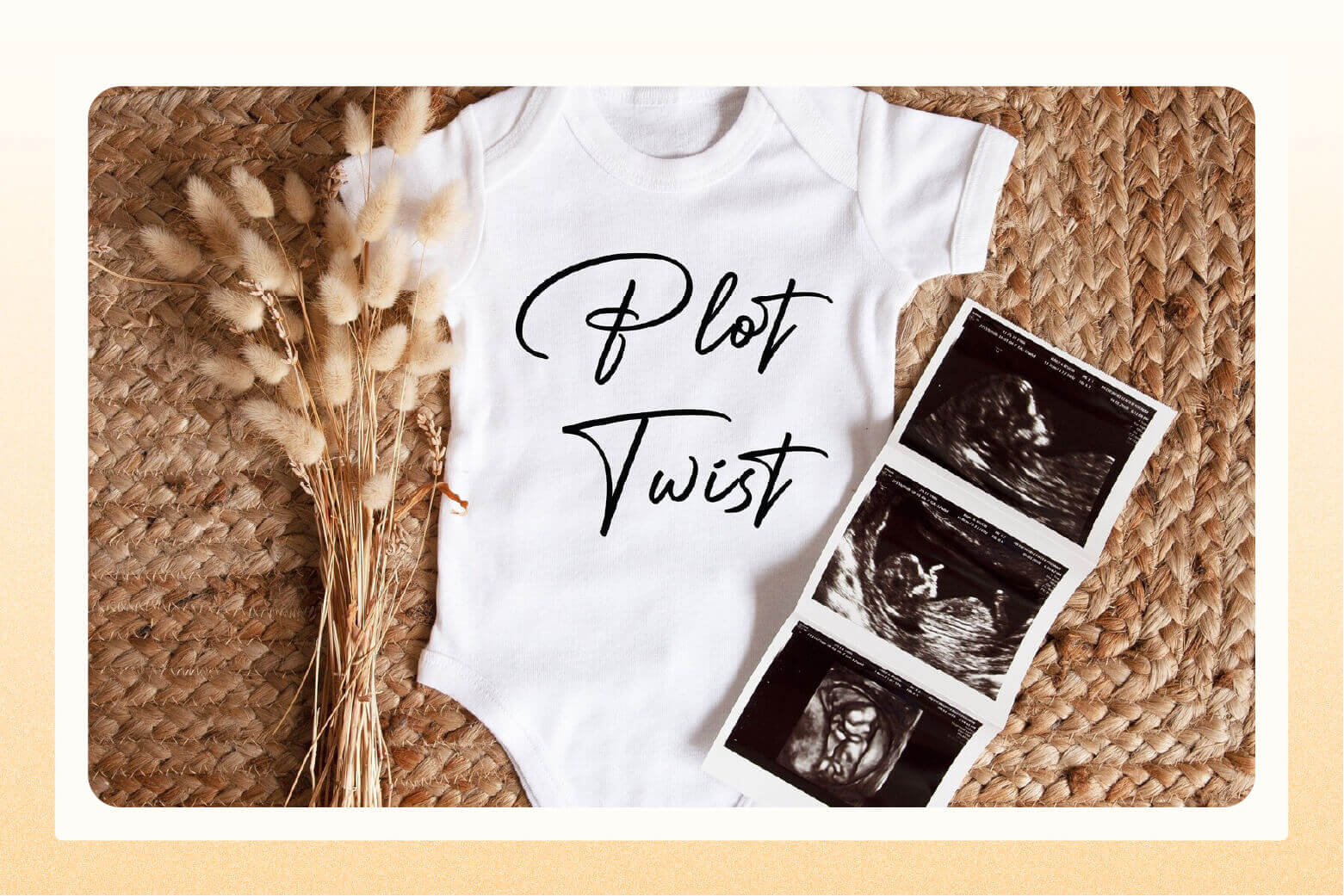 White onesie that says "plot twist" with a sonogram laying on top of it