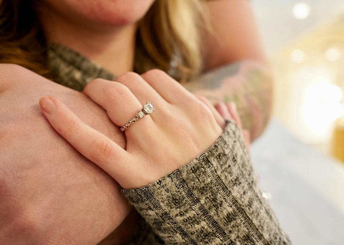 Woman wearing a vintage engagement ring with an intricate design