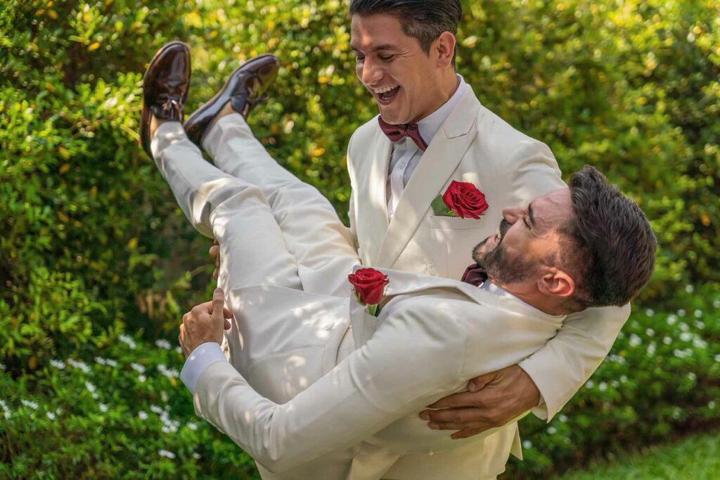A groom holding his partner at their wedding