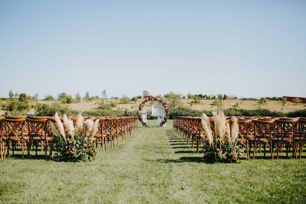 outdoor wedding ceremony setup with chairs on a field of grass at the ethereal open air resort in san diego
