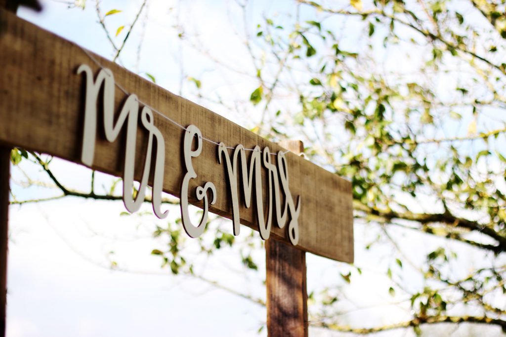 mr and mrs signage on wood palette at wedding