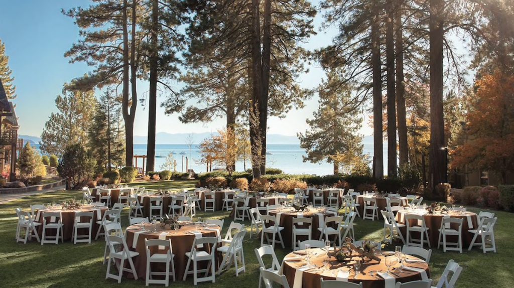 tables for a wedding reception set up on a lawn by the lake at the hyatt regency lake tahoe resort, spa and casino