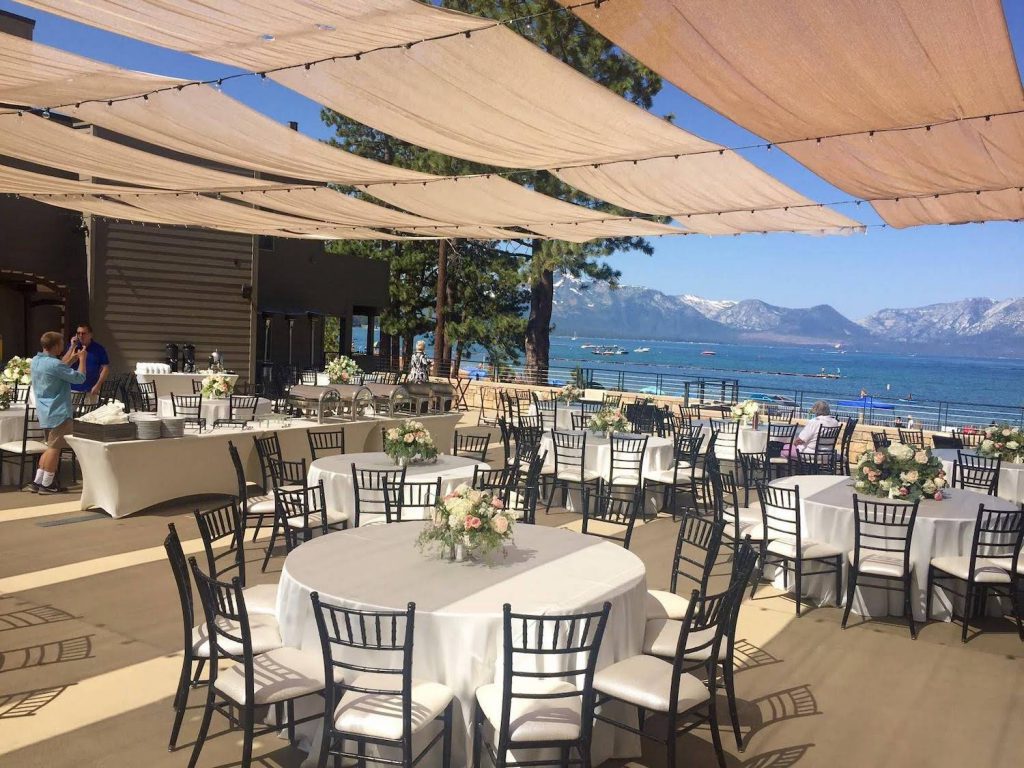 tables set for a wedding reception on the grand rooftop terrace at the landing resort & spa in lake tahoe