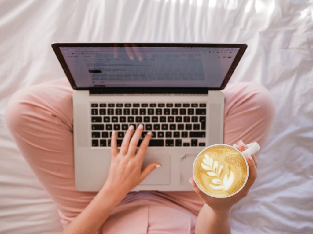 Person sipping Latte at their Laptop