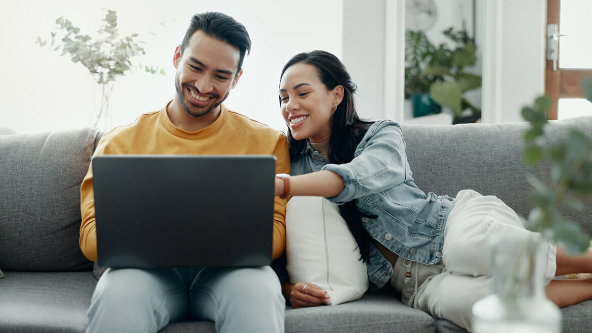 Happy couple planning their wedding on the computer