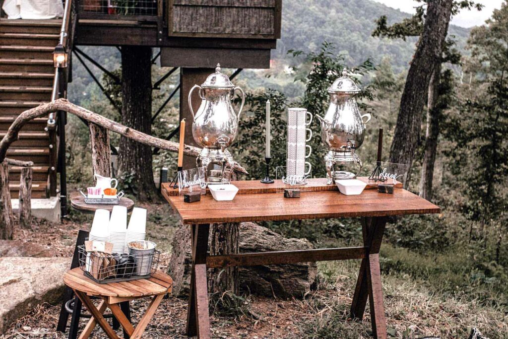 Rustic coffee bar with silver canisters in the woods