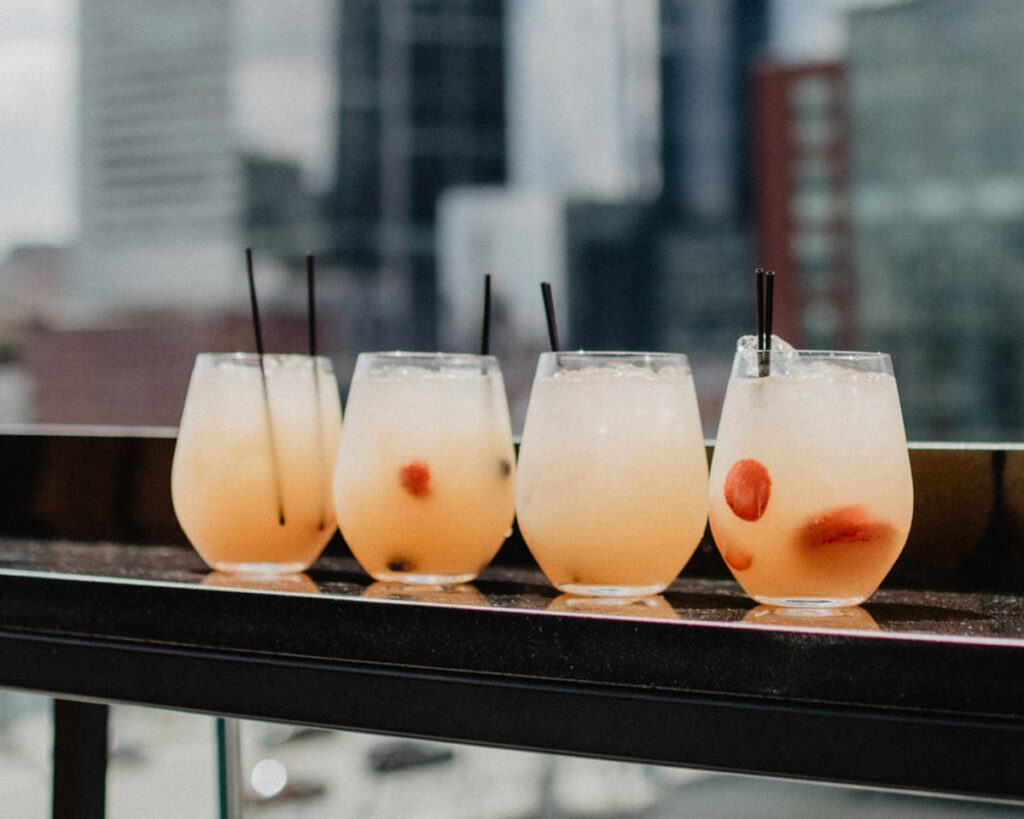 Four glasses of white wine sangria on a ledge