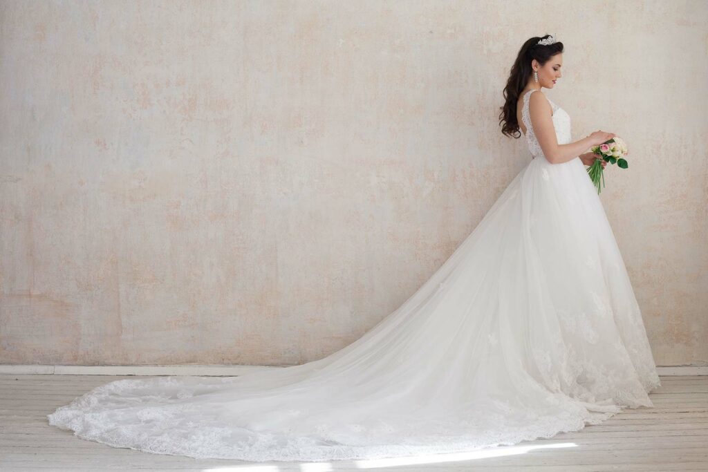 Woman wearing a wedding dress with a cathedral train