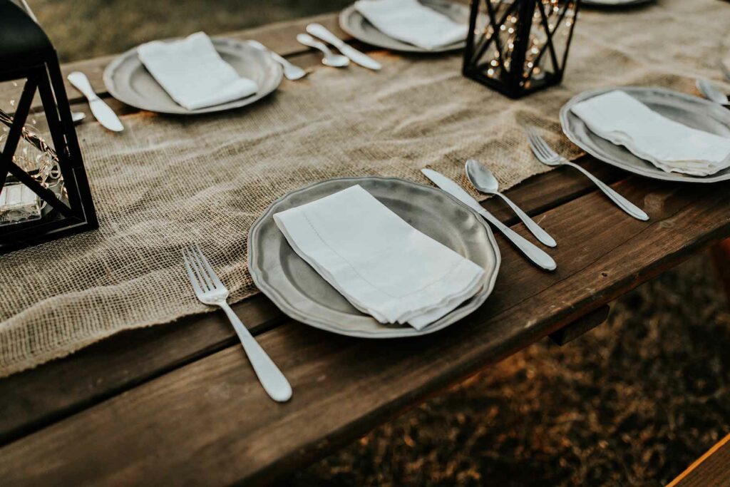 Burlap fabric is used as a table runner for a budget-friendly fall decoration
