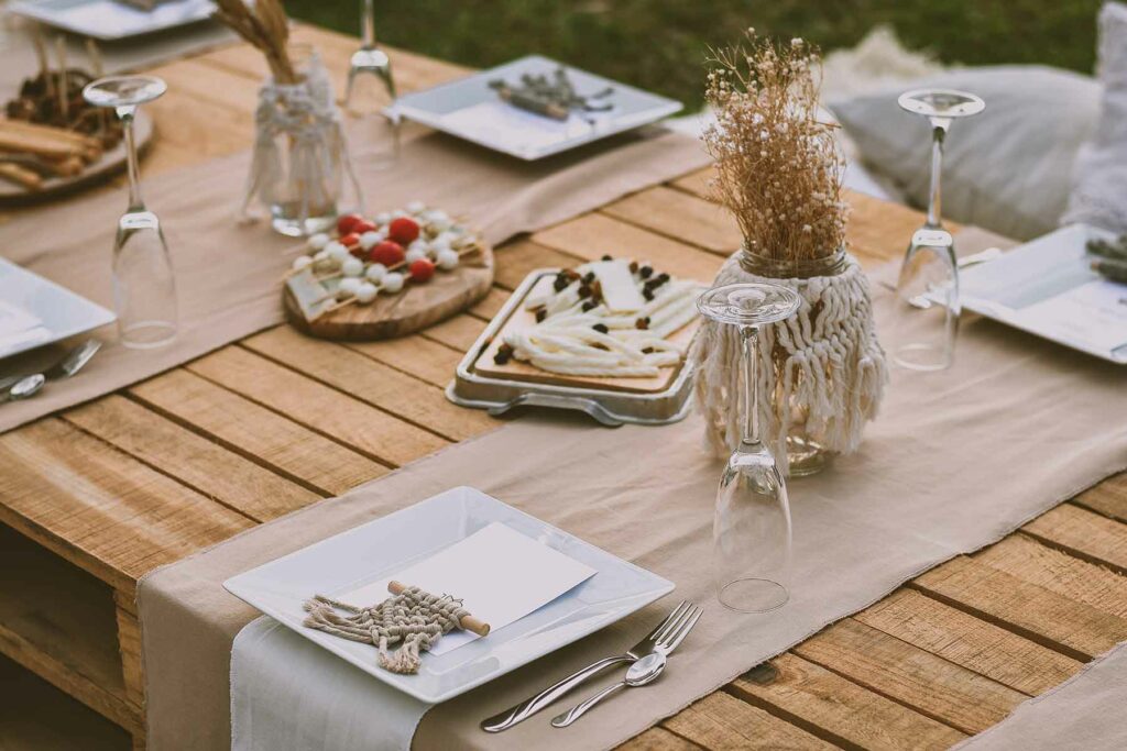 A mason jar decorated with a woven design adds a fun boho feel to a wedding table