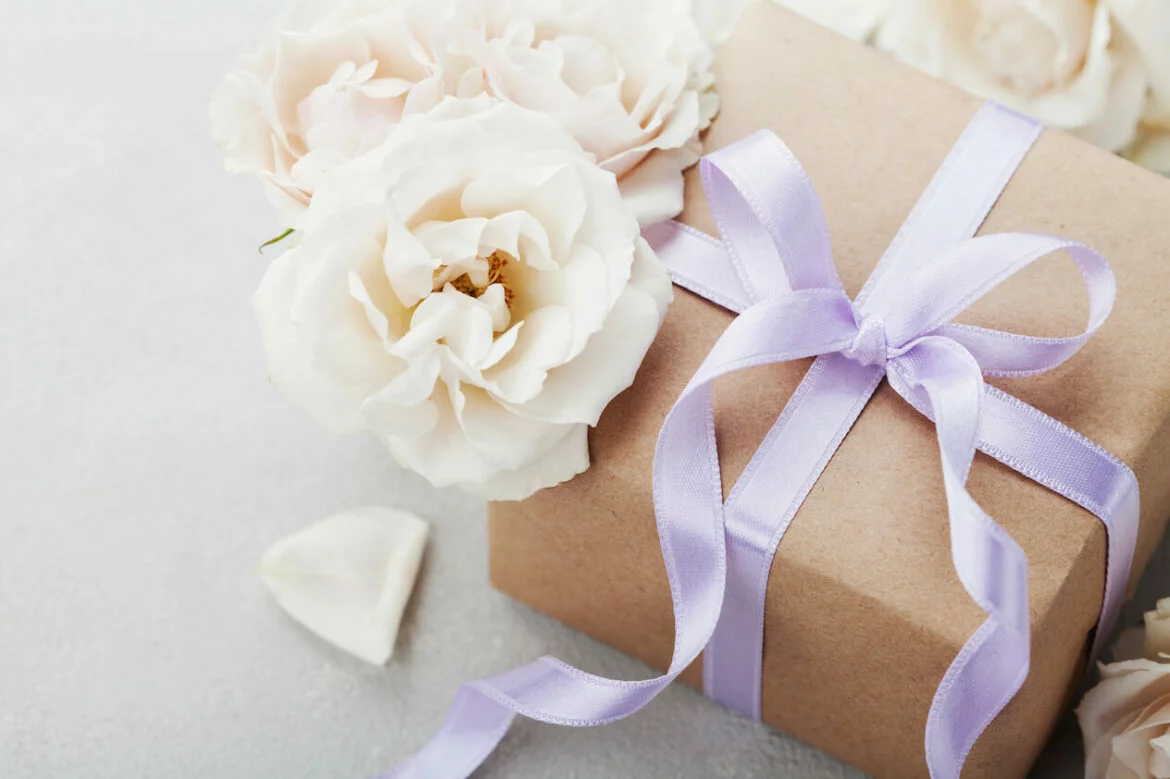 wedding gift with lavender ribbon and white flowers
