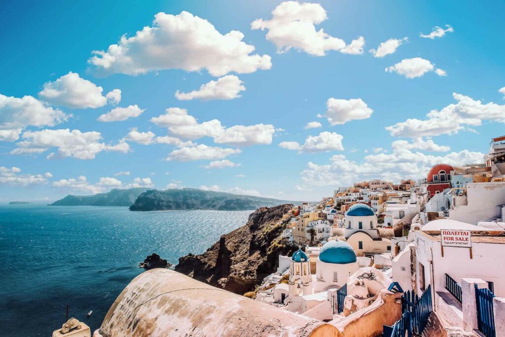 White houses in Santorini, Greece, with views of the blue sky and sea