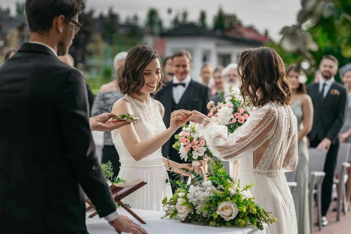 Two women exchanging rings during their wedding