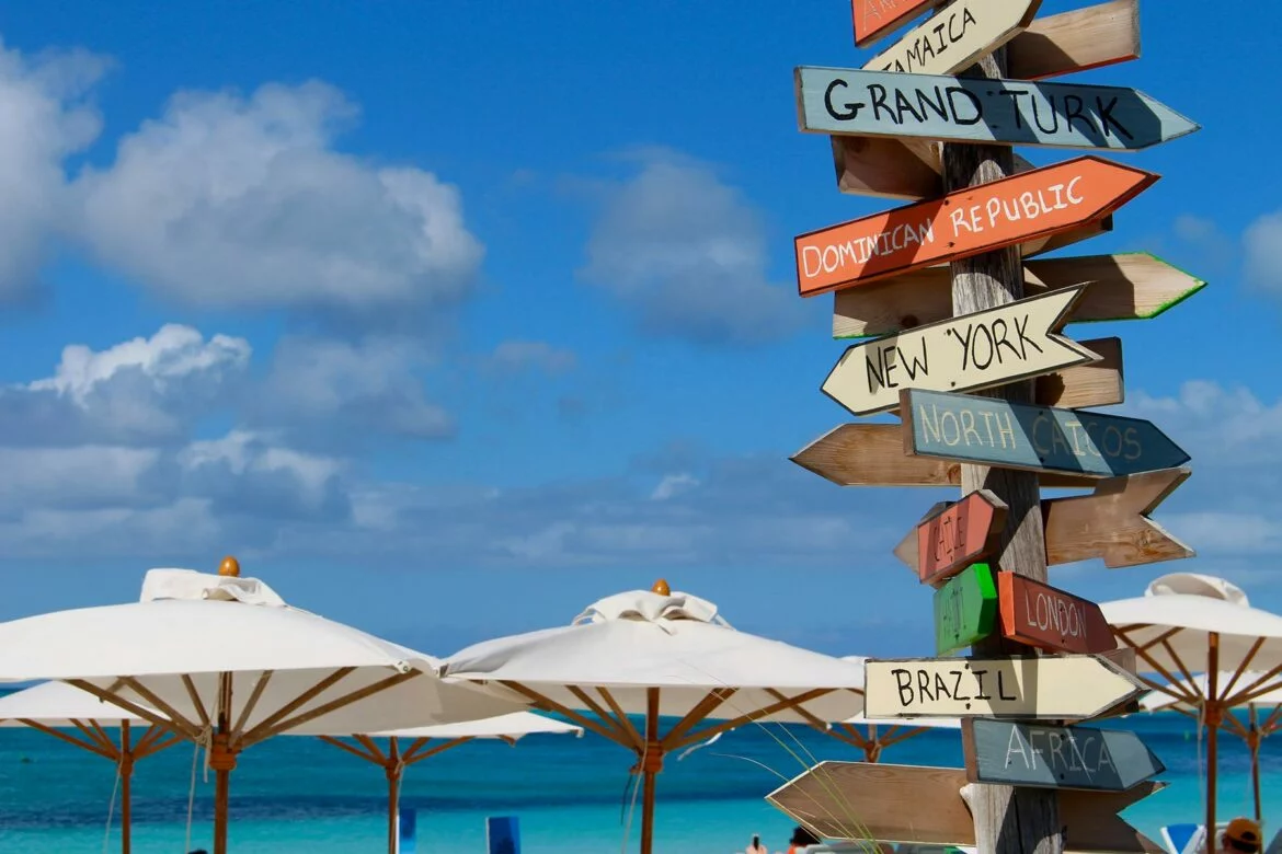 A tourist sign pointing toward nearby locales at Grace Bay Beach in Turks and Caicos