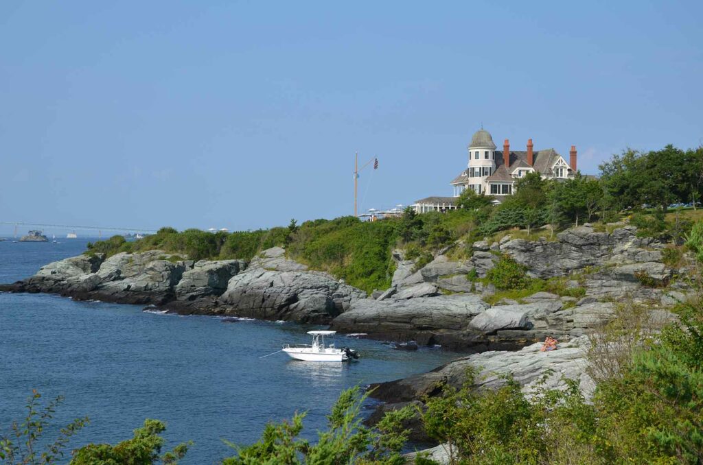 A stately home on a cliffside overlooking the water in Newport, Rhode Island