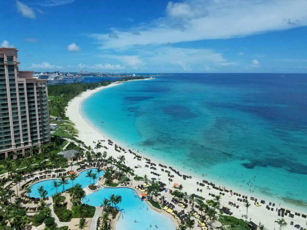 An aerial shot of a Paradise Island resort and pool along the water