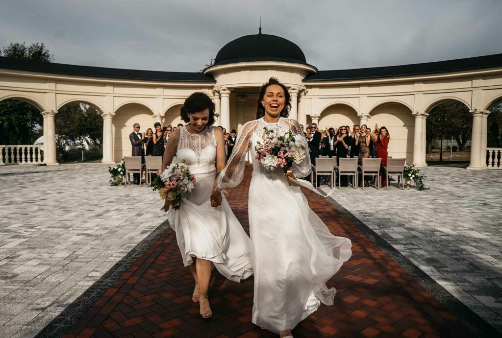 Same-sex couple exiting the ceremony during their wedding recessional