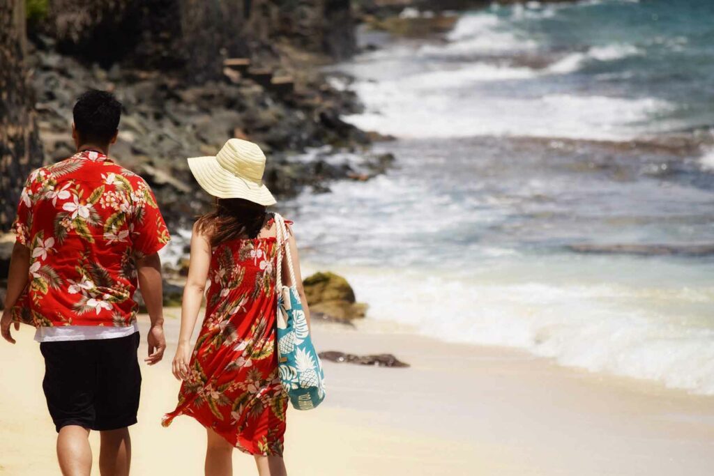 A couple walking on the beach during their Hawaii honeymoon