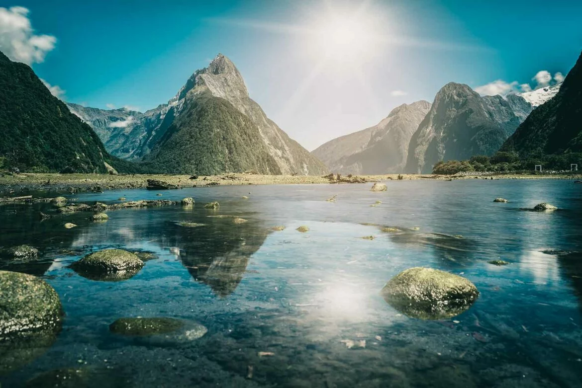 Mountain landscape reflected on the water at Milford Sound, a popular New Zealand honeymoon attraction