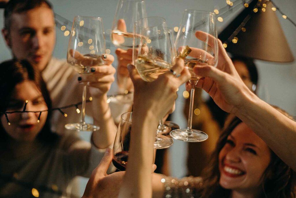 A group toasting the couple with wine glasses at a wedding shower