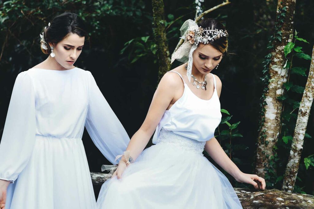 A couple wearing white dresses holding hands at their destination wedding in Costa Rica