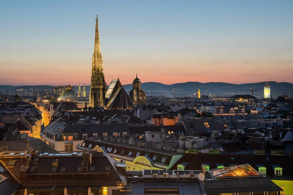 A nighttime view of rooftops in Vienna