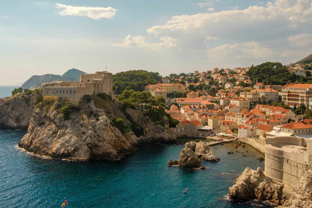 The coast of Dubrovnik, Croatia, with buildings perched on a rugged cliffside