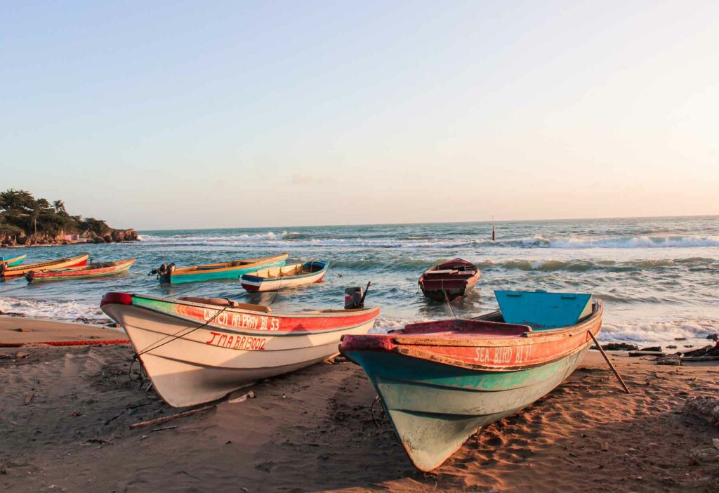 Colorful boats sitting on the shoreline at Treasure Beach, Jamaica