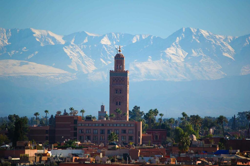 City buildings in Marrakech, Morocco with mountains in the background