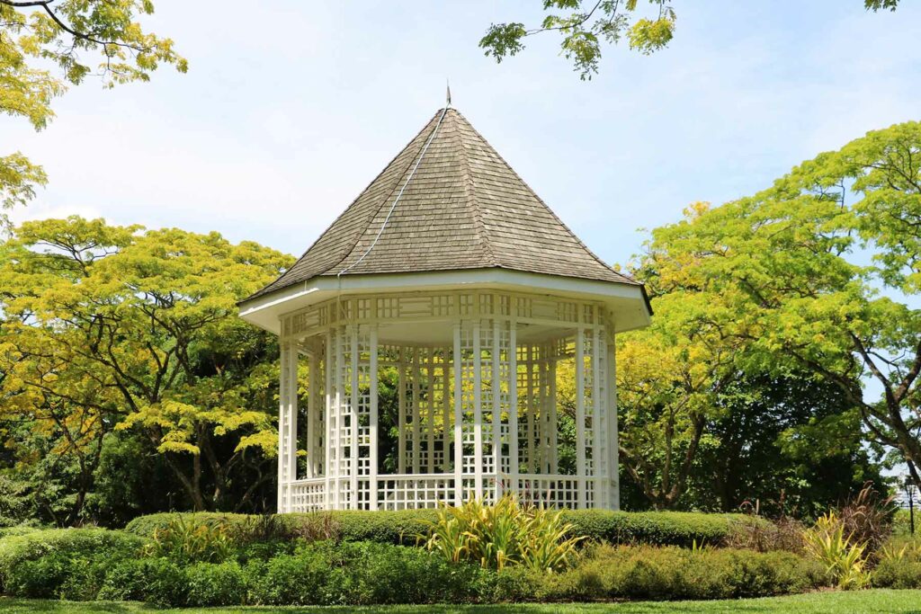 An outdoor proposal location at a gazebo surrounded by trees and greenery