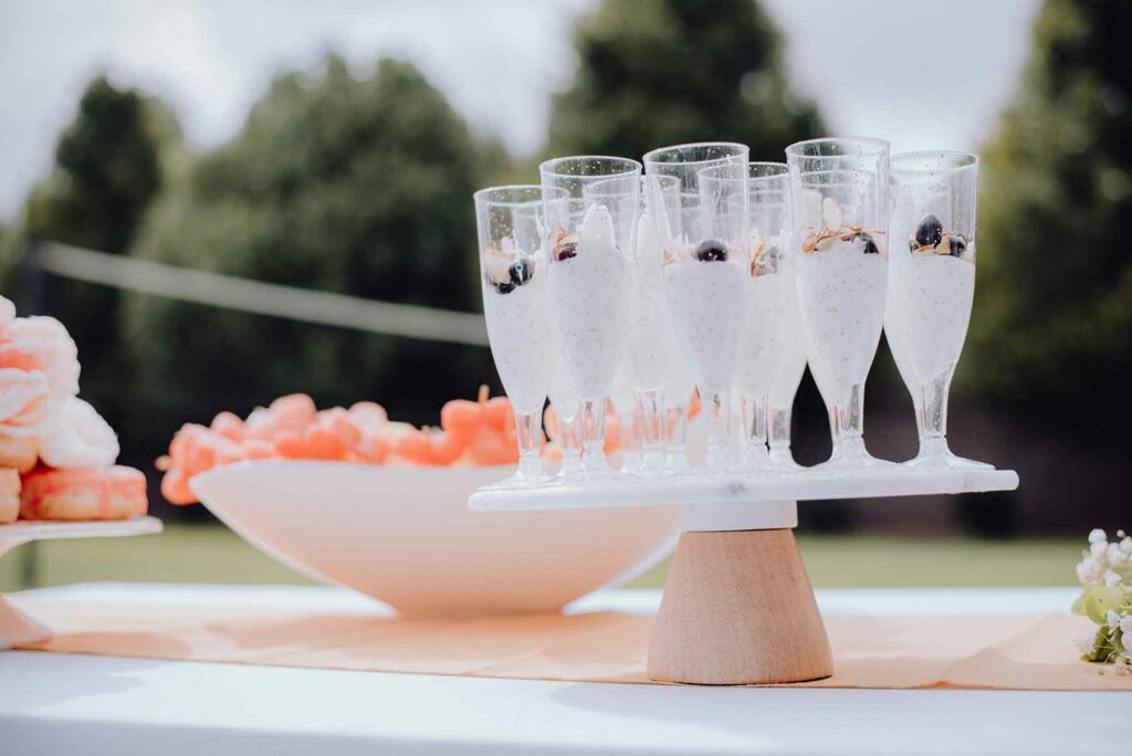 Close-up of fresh wedding food for a brunch wedding, including yogurt parfaits in champagne flutes and fresh fruit