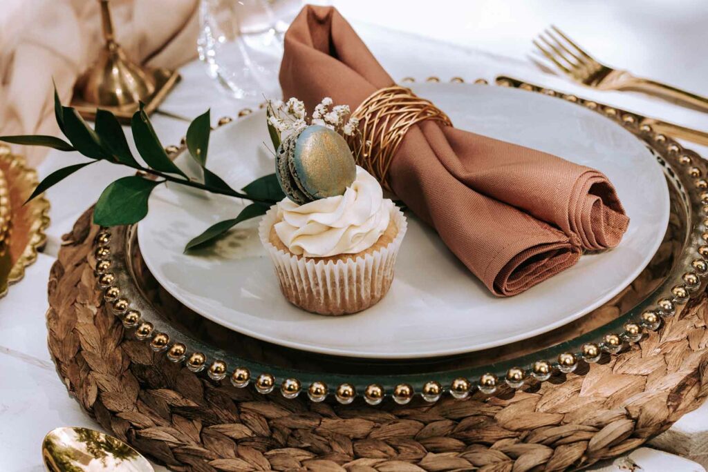Cupcake sits on the place setting of a wedding shower party table