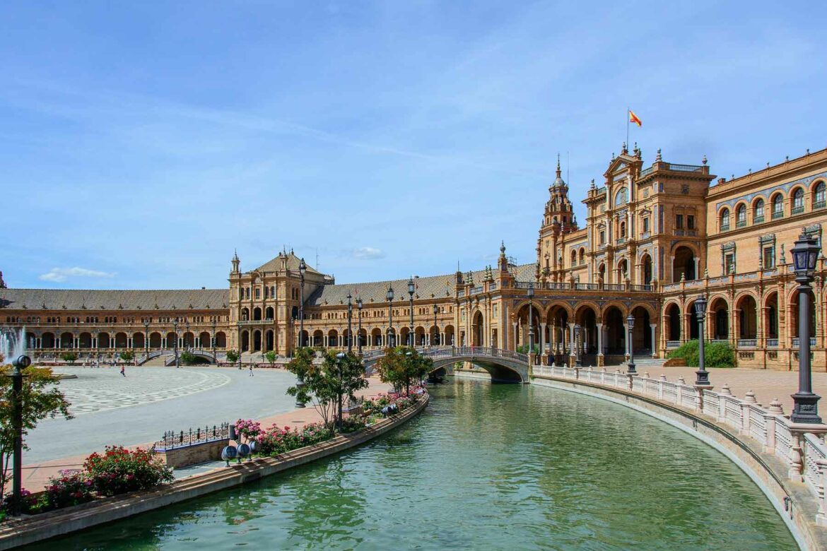 A view of a historic building along the water in Seville, Spaine