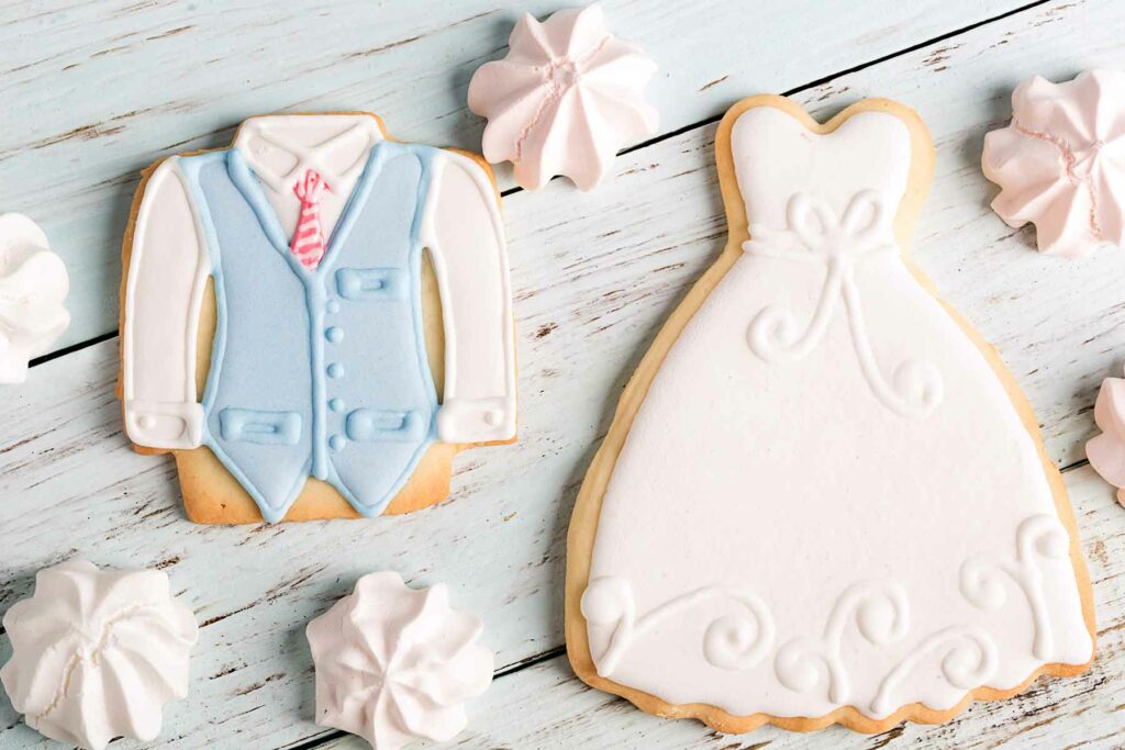 Custom wedding cookies in the shape of a dress and shirt and tie