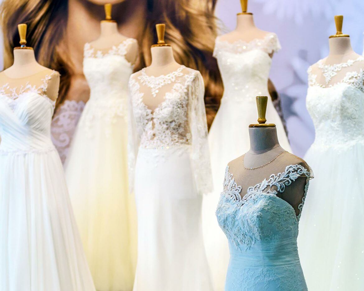 A display of six wedding dresses on mannequins in various styles