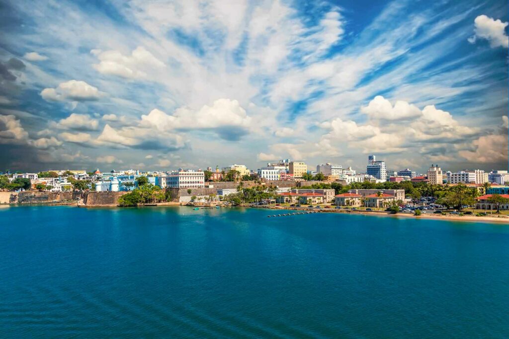 A view of the shoreline in Old San Juan in Puerto Rico with colorful buildings in the background