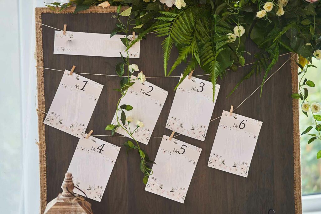 A wedding seating chart with blank cards for tables 1 through 6 
