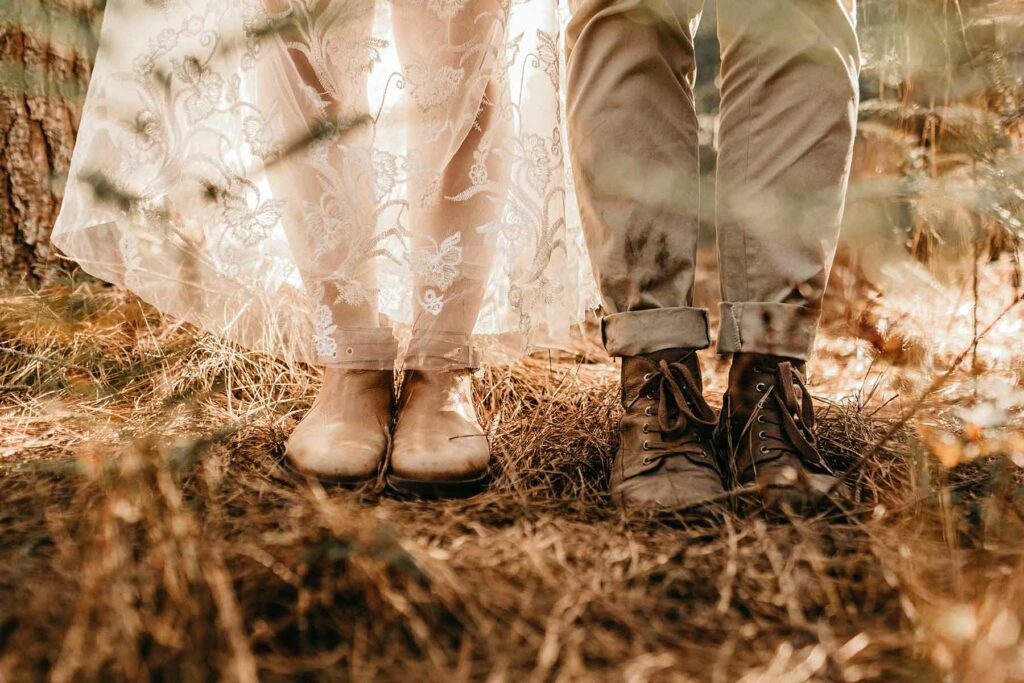 What to wear in engagement photos: close-up of a woman's feet in flats and a man's feet in boots