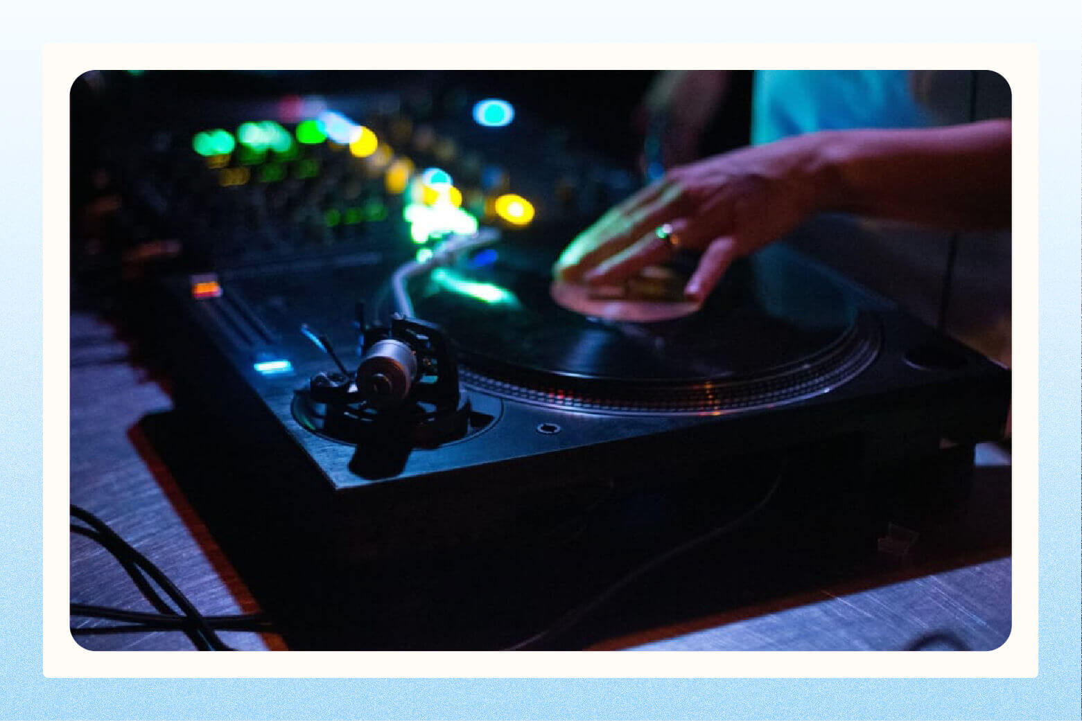 close up image of wedding DJ's hand on a turntable